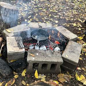 Fire pit is large enough to cook on, grill and cast iron were brought by us.
