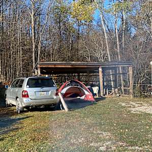 Lean to with picnic table, chairs, and where the wood bundle was stored