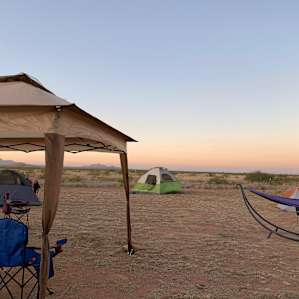 The best place to tent camp is the mowed area in front of the house, remember to bring camp chairs and a hammock (like we did) or a tarp to put down when looking at the stars . Otherwise, prickles (high desert). We were a group of 7 and had plenty of space.