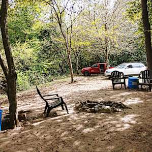 View facing entry/parking (fishing hole is behind the camera). Other sites are past the vehicles.