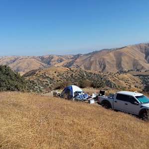 Standing on the hillside just above the parking loop. Tent is set up on the road where the ground is level and space is sufficient to place a 6 person tent.
Tree on the left is where site 1 picnic table is located. My Ford Raptor was about as wide as road in.