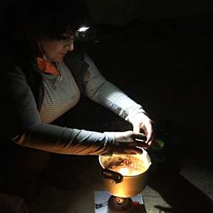 Janeane cooking Shaksuka at Site #3 Earth Shrine