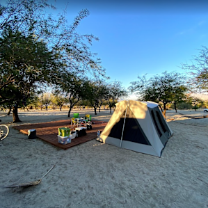 The camping area is large. Sandy, with trees