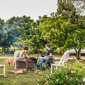 There is a communal raised fire pit with chairs around it for campers to use
