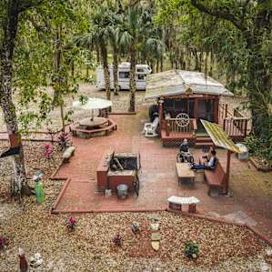 A view of the Bunk House and the outdoor tables and fire pit surrounding it
