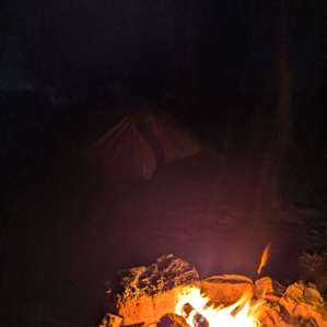 Firepit with tent in the background.