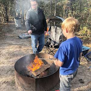 My husband and middle son at our campsite (#3) maintaining our campfire.
