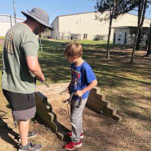 My husband and middle son trying a game of horseshoes in the common area.