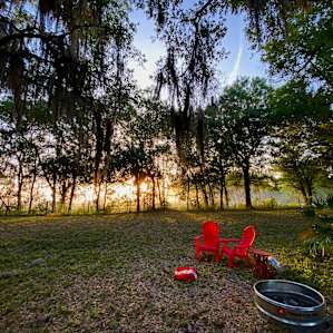 Sunrise by the fire pit. Chairs are part of the camp site.