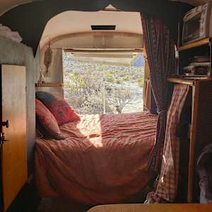 The Gypsy Wagon's bed is right next to the back gate, so you can comfortable relax inside while feeling like you're outside.