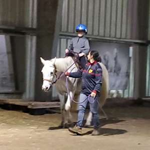 Inside the barn where loredana walked with the horse while my son was riding her.