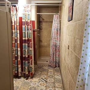 One of the showers plus changing room