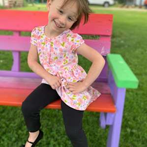 Pretty girl on the pretty rainbow bench