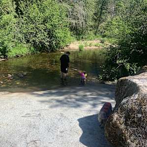 My husband and daughter in the river on the property.