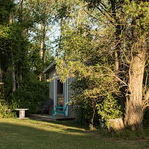 Sunrise and sunset cast beams of light across the property making this front porch the perfect spot to breathe deep and enjoy the sounds of nature all around.