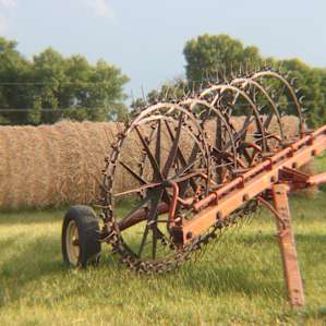 Some more vintage equipment, along with baled hay.