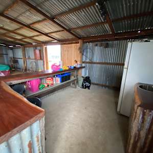 Communal kitchen with fridge, sink and bench space.
