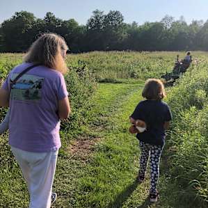 Grandmother and grand daughter off to the tent