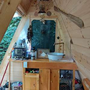 View of small wood stove, sink, inverter cabinet and other provided supplies.