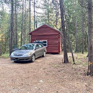 The cabin is in woods up on a small hill along with 2 other permanent tents/yurts.