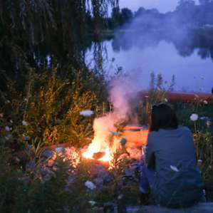 Cozy and warm fire next to the lake.