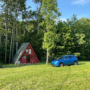 The cabin is at the bottom of a hill in a very private clearing