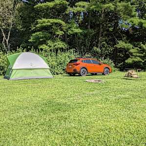 I didn't get a full picture of the whole yard with all camp sites, but this was a corner we stayed at. NOTE: you do not leave your car next to your tent, but they allow you to pull down the to set everything up. Table and grill are not pictured, but included.