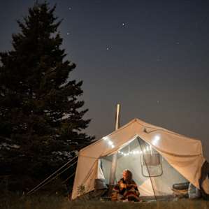 Trapper's tent at night. Beautiful dark skies, my spot was RIGHT on the river.