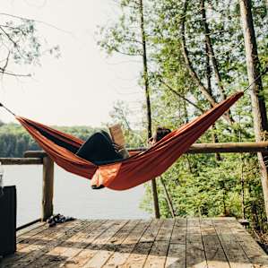 Relaxing and reading a book in the hammock. Perfect place to slow down and unwind.