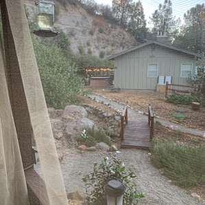 View from the outdoor kitchen - jacuzzi, sitting pond, and bocce ball court are behind the main house across the bridge.