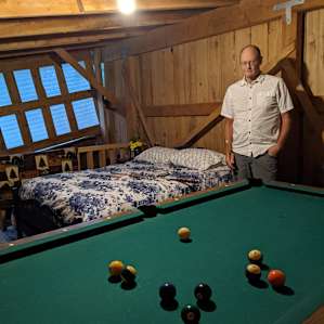 Inside the loft of the Rustic Barn you will find a pool table next to the bed!
