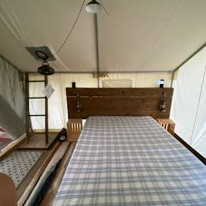 Queen sized bed in canvas tent
