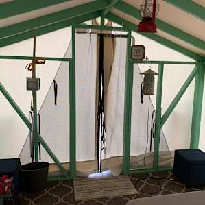 Front “door” has two layers: solid and screen. You can see phone charging station on the left, bug zapper on the right, and electric lantern top center. I had more than enough light to read on my bed at night.
