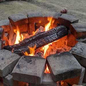 The fire ring is smaller than the wood, but you can make it work.