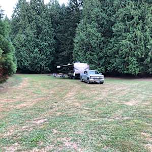 So much room to spread out or play lawn games. There is a fire ring and picnic table behind the trailer.