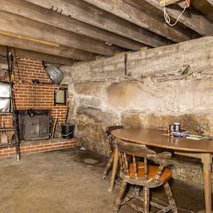 A wood stove and table provide a great space for card games!