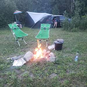View of how we set up at the site. We tested car-sleeping for fun, with a bug net over our trunk. But there was LOADS of space for tents. The trees give evening shade for a nice tent spot. This site would be great in cooler weather with nice morning sun.