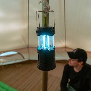 The inside of the tent had a lamp hanging from the pole in the middle.