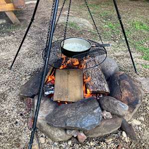 Easy setup for cooking over the fire. Plenty of firewood stacked nearby