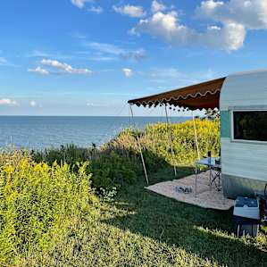 Lake-view tent site by green cabin