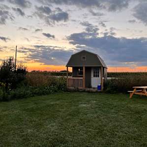 Lake-view tent site by green cabin