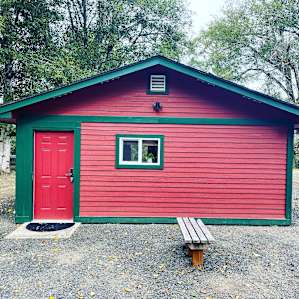 Super cute cabin with traditional red and green color scheme- has everything you need for an escape to the woods/river.