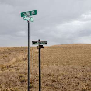 When you find these crossroads, the plot of land is on your right. It is a triangle lot.