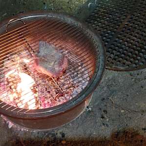 Weber grill grate fits perfectly on the fire ring. Wood fired steak for the win!