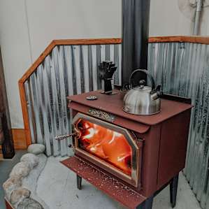 Beautiful wood stove, keeps the tent so warm on chilly days. It gets very hot on top, perfect to put the kettle on for tea