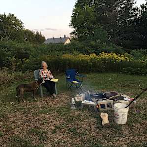 My mom enjoying campfire cooked food.