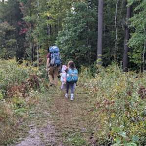 Hiking into campsite with the huge wheelbarrow full of stuff
