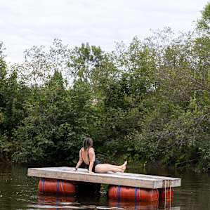 Floating dock in the river that runs along the back of the property