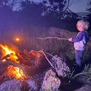 The toddler loved the open fire at night.