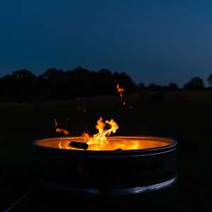Cooking hotdogs by the fire.